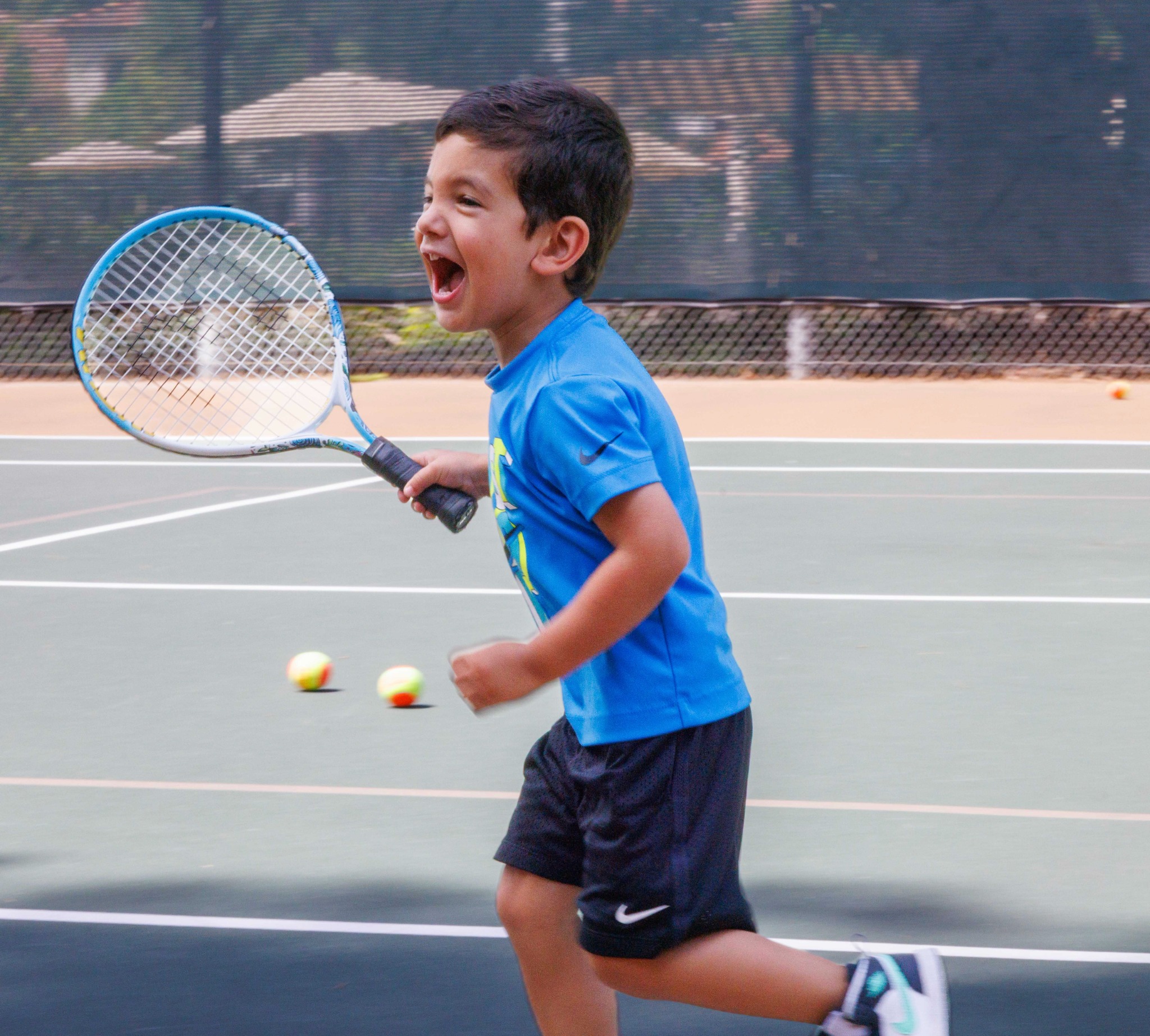 Junior tennis player enjoying a lesson