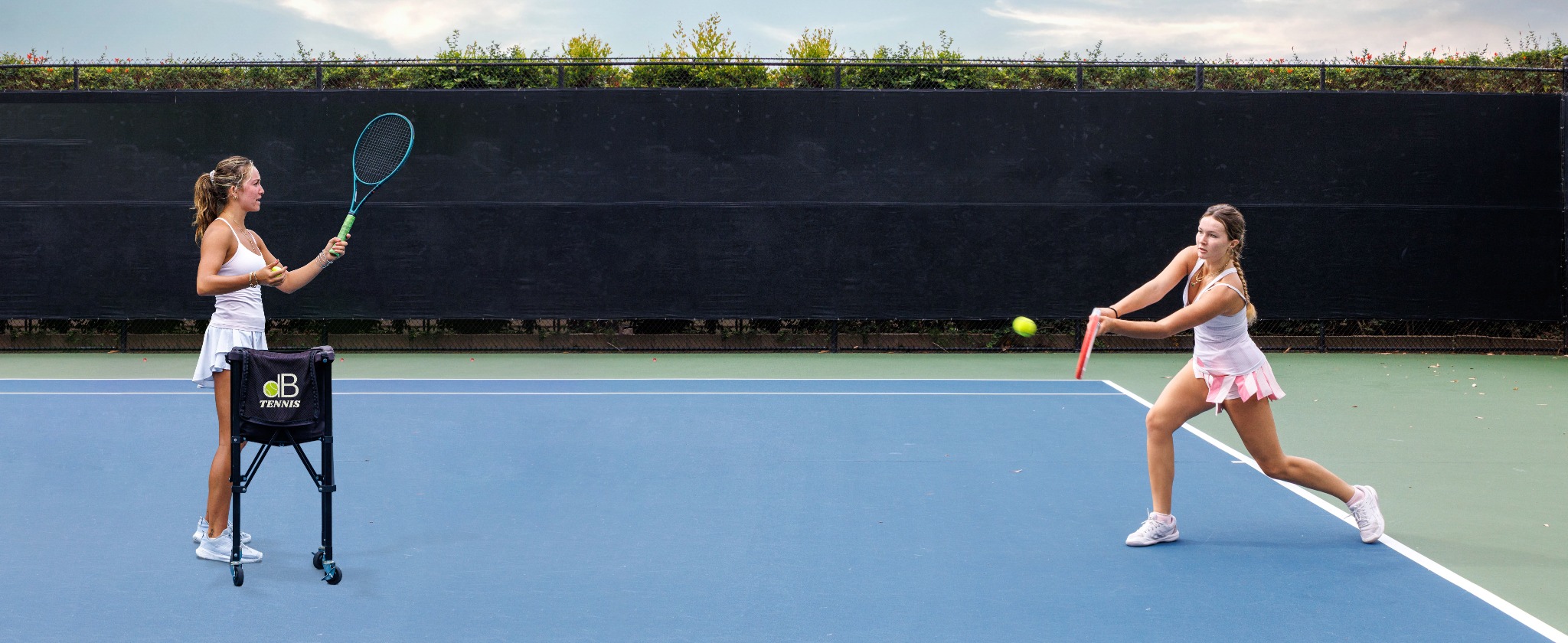 DB Tennis coach and player on court