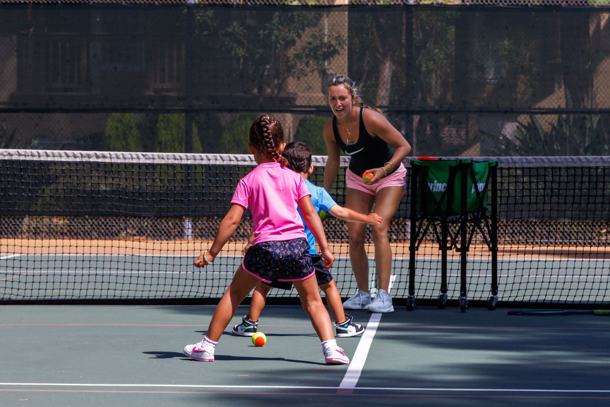 DB Tennis coach with children on court