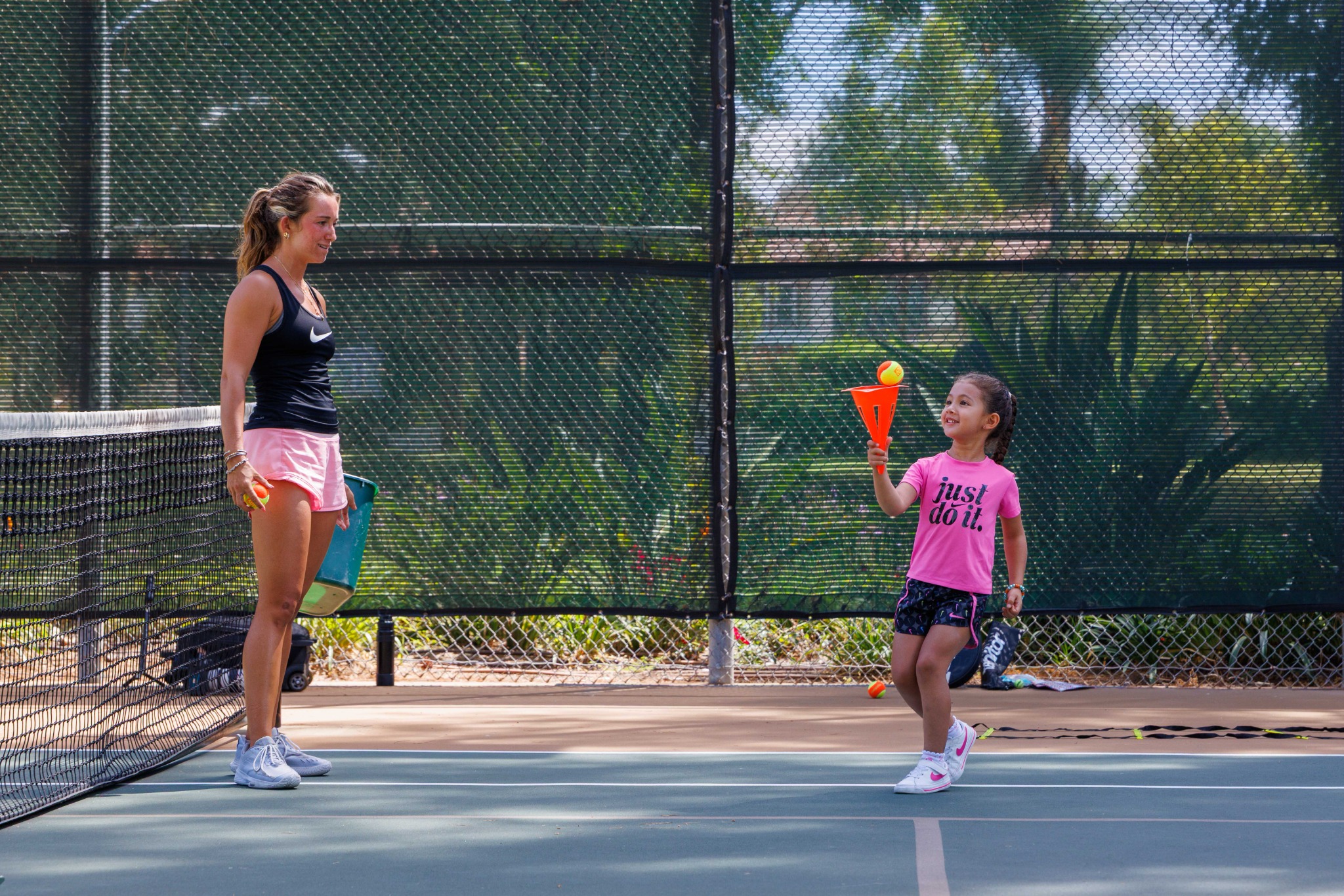 DB Tennis coach working one-on-one with a young player