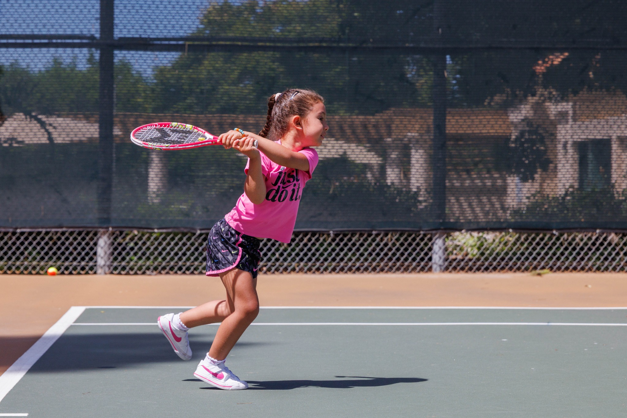Junior tennis player hitting on court