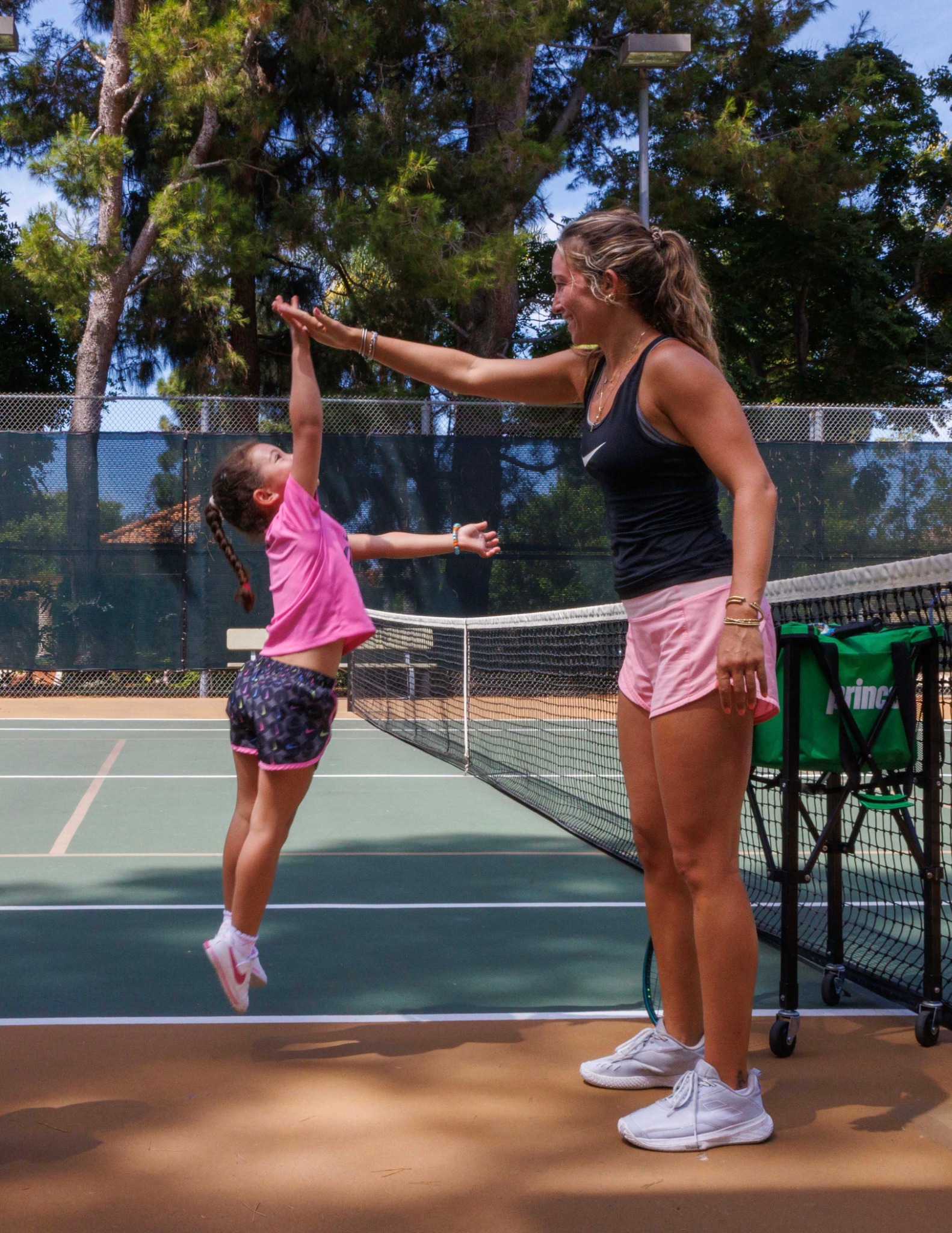 DB Tennis coach celebrating with a junior player